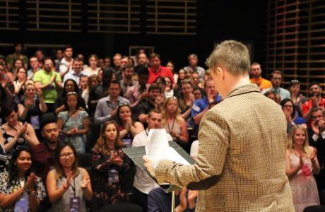 A man giving a lecture to a crowd of people